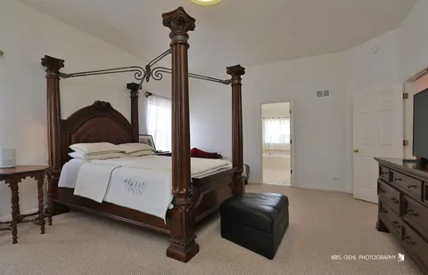 a bedroom with a bed and a television