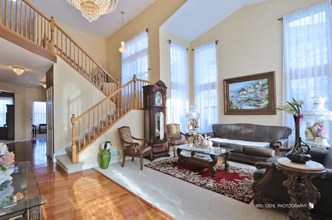 a living room with furniture and stairs