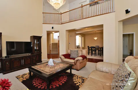 a living room with furniture a flat screen tv and a table