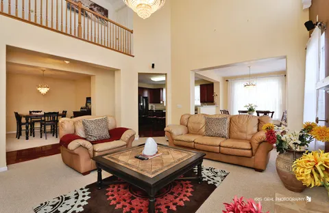a living room with furniture a rug and a chandelier