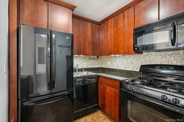 a kitchen with stainless steel appliances granite countertop a refrigerator stove and microwave