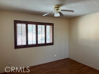 15100 Blackfoot Road Apple Valley, CA 92307 - Photo 15 of 18 a view of an empty room with a window and wooden floor
