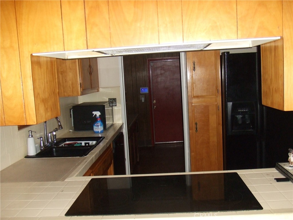 15100 Blackfoot Road Apple Valley, CA 92307 - Photo 5 of 18 a view of kitchen with stainless steel appliances a refrigerator and a stove
