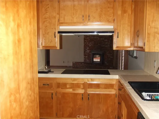 a kitchen with granite countertop a sink a stove and a microwave