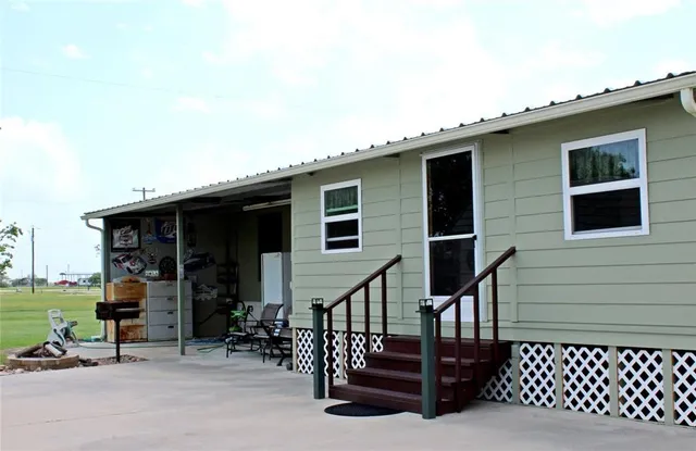 a view of a house with yard and sitting area