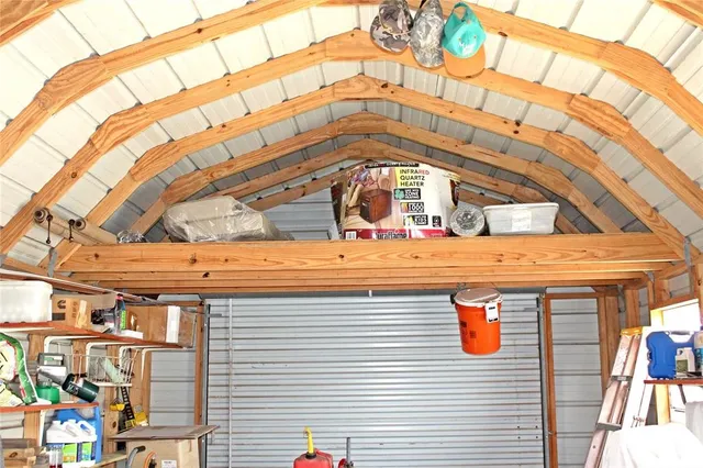 a grassy field with trees in the background