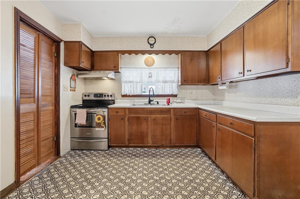 121 Orchard Drive Prospect, PA 16052 - Photo 11 of 46 a kitchen with a sink stove and cabinets