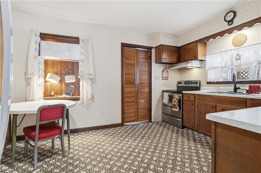 121 Orchard Drive Prospect, PA 16052 - Photo 14 of 46 a kitchen with stainless steel appliances kitchen island granite countertop a refrigerator and a stove top oven