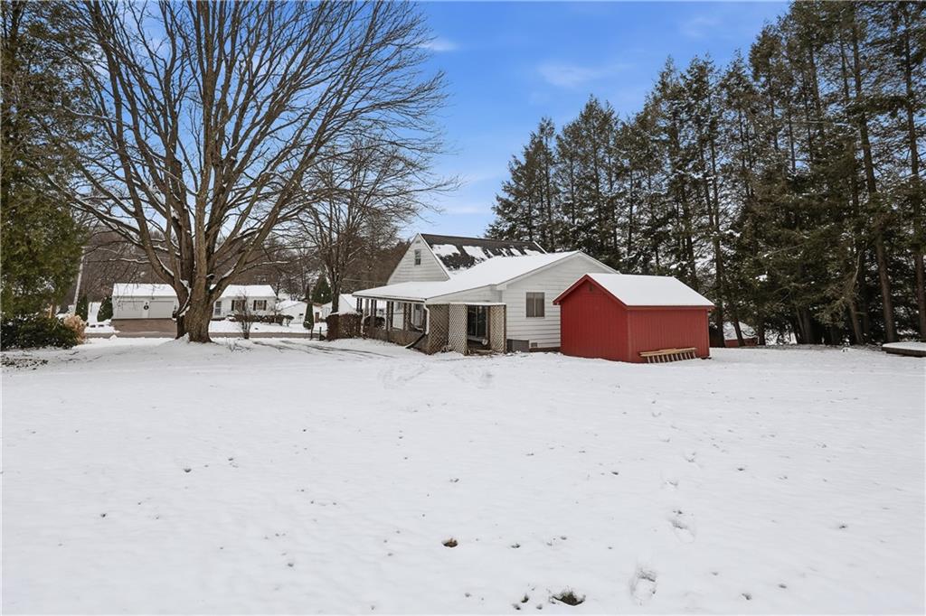 121 Orchard Drive Prospect, PA 16052 - Photo 38 of 46 a yellow and white house with a snow in the yard