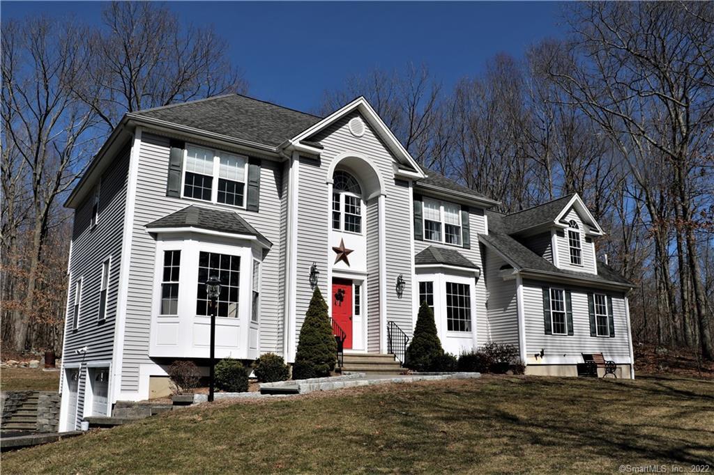 54 New Lebbon Road Newtown, CT 06482 - Photo 1 of 1 a front view of a house with a yard
