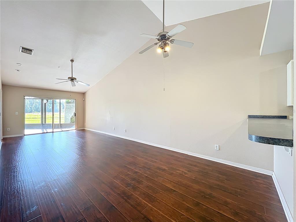 100 Silver Sea Road Winter Springs, FL 32708 - Photo 11 of 44 a view of an empty room with wooden floor and a window