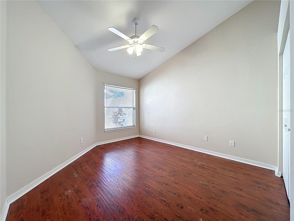 100 Silver Sea Road Winter Springs, FL 32708 - Photo 16 of 44 an empty room with wooden floor fan and windows