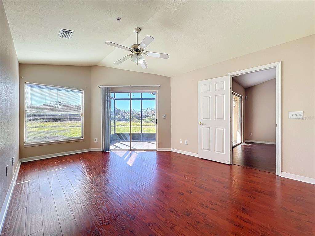 100 Silver Sea Road Winter Springs, FL 32708 - Photo 20 of 44 a view of an empty room with wooden floor and a window