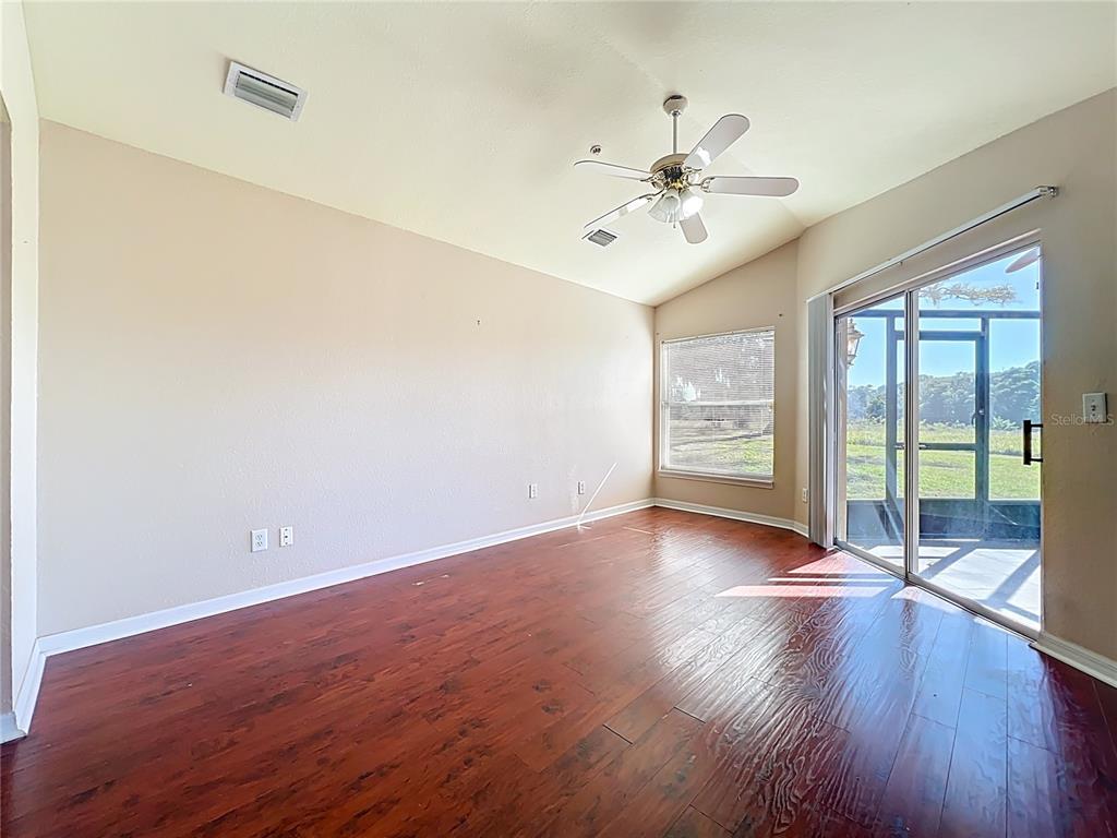 100 Silver Sea Road Winter Springs, FL 32708 - Photo 21 of 44 an empty room with wooden floor fan and windows