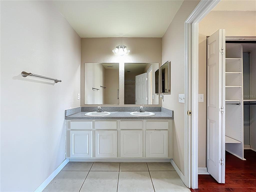 100 Silver Sea Road Winter Springs, FL 32708 - Photo 26 of 44 a bathroom with a granite countertop sink a mirror and a vanity