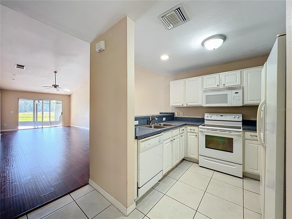 100 Silver Sea Road Winter Springs, FL 32708 - Photo 8 of 44 a kitchen with stainless steel appliances granite countertop a stove and a refrigerator