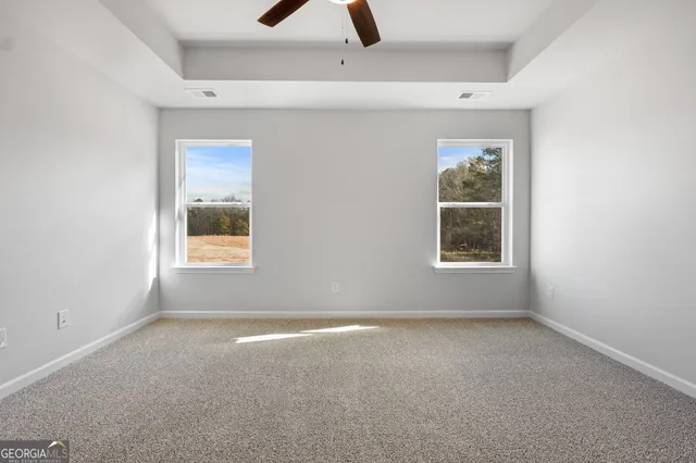 an empty room with windows and closet