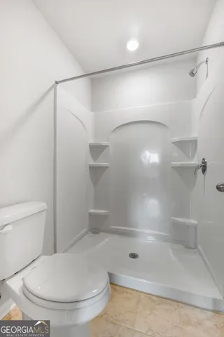 a bathroom with a shower and a toilet