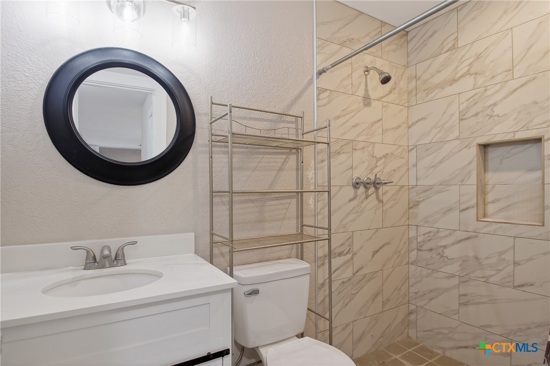 617 Bartlett Road Victoria, TX 77905 - Photo 14 of 30 a bathroom with a granite countertop toilet sink mirror and vanity