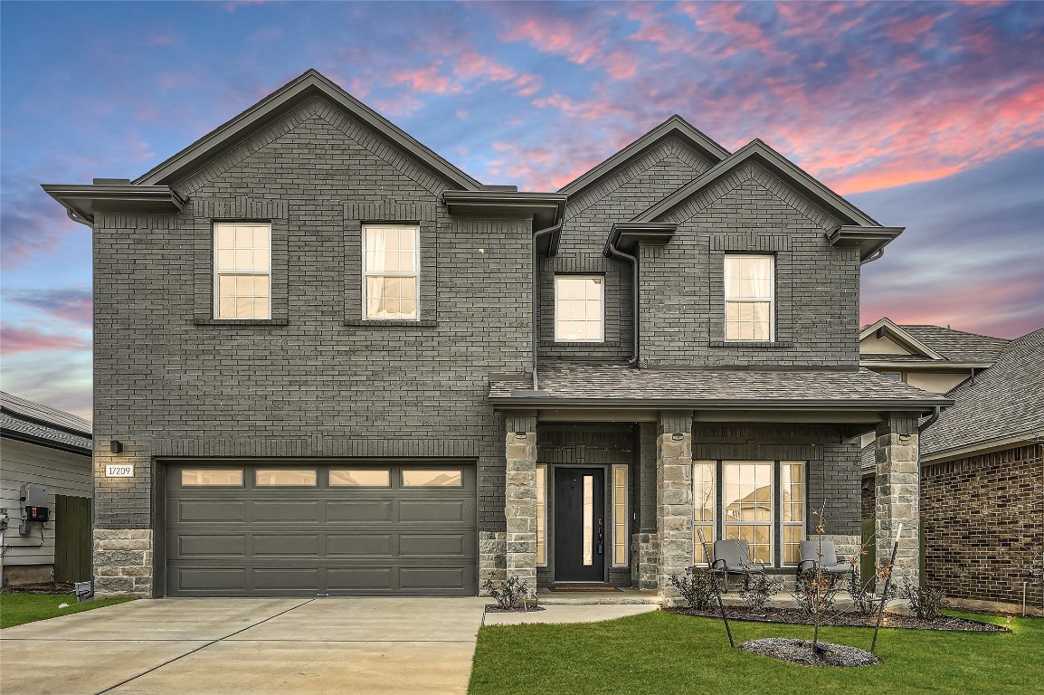 a front view of a house with garden