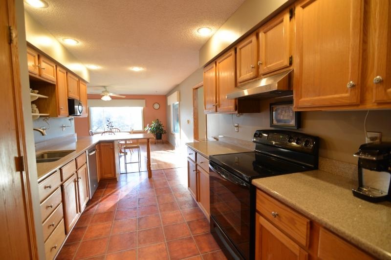 6761 Sentinel Road Rockford, IL 61107 - Photo 8 of 21 a kitchen with stainless steel appliances granite countertop a stove a sink and a refrigerator
