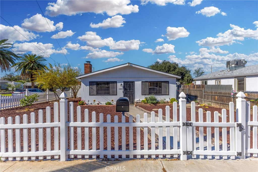 1003 Lawton Street Redlands, CA 92374 - Photo 1 of 1 a front view of a house with a garden