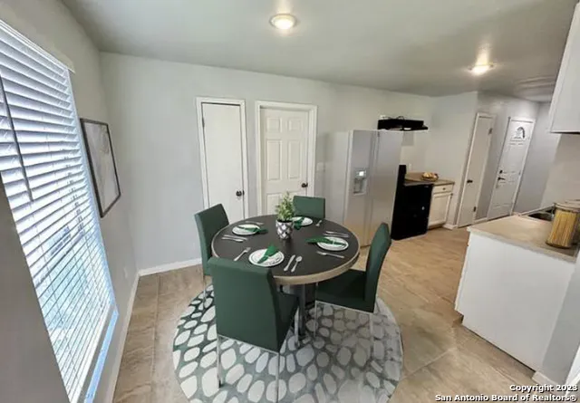 a living room with furniture and a mirror