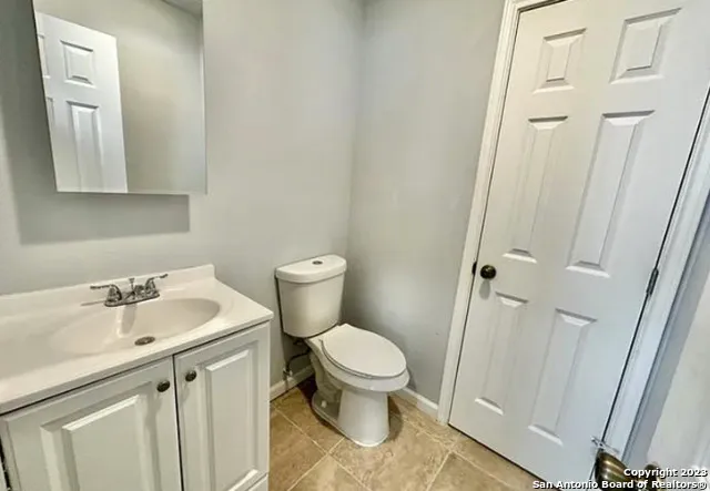 a white toilet sitting next to a bathroom sink