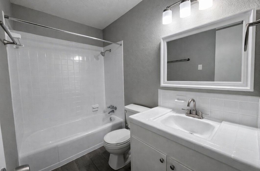 414 Marshall Street, Unit 21 Houston, TX 77006 - Photo 6 of 7 a bathroom with a sink toilet and shower