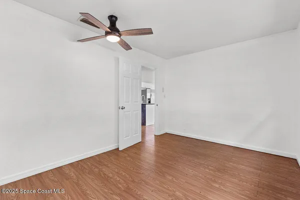 an empty room with windows and closet