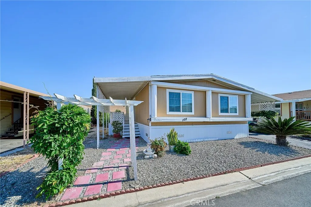 4000 Pierce Street, Unit 168 Riverside, CA 92505 - Photo 3 of 34 a front view of a house with garden
