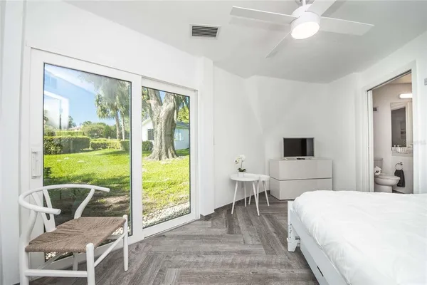 a bathroom with a granite countertop toilet a sink and a mirror