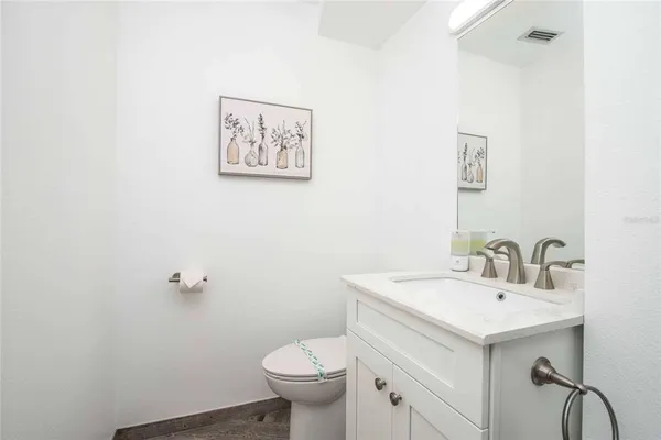 a kitchen with stainless steel appliances a table chairs and a refrigerator