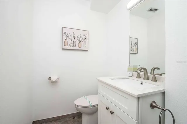 a kitchen with stainless steel appliances a table chairs and a refrigerator