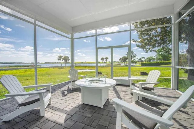 a living room with a bed and a table with wooden floor