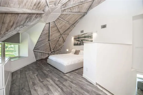 a bedroom with a bed and a ceiling fan