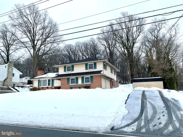 a view of a house with a snow in the yard