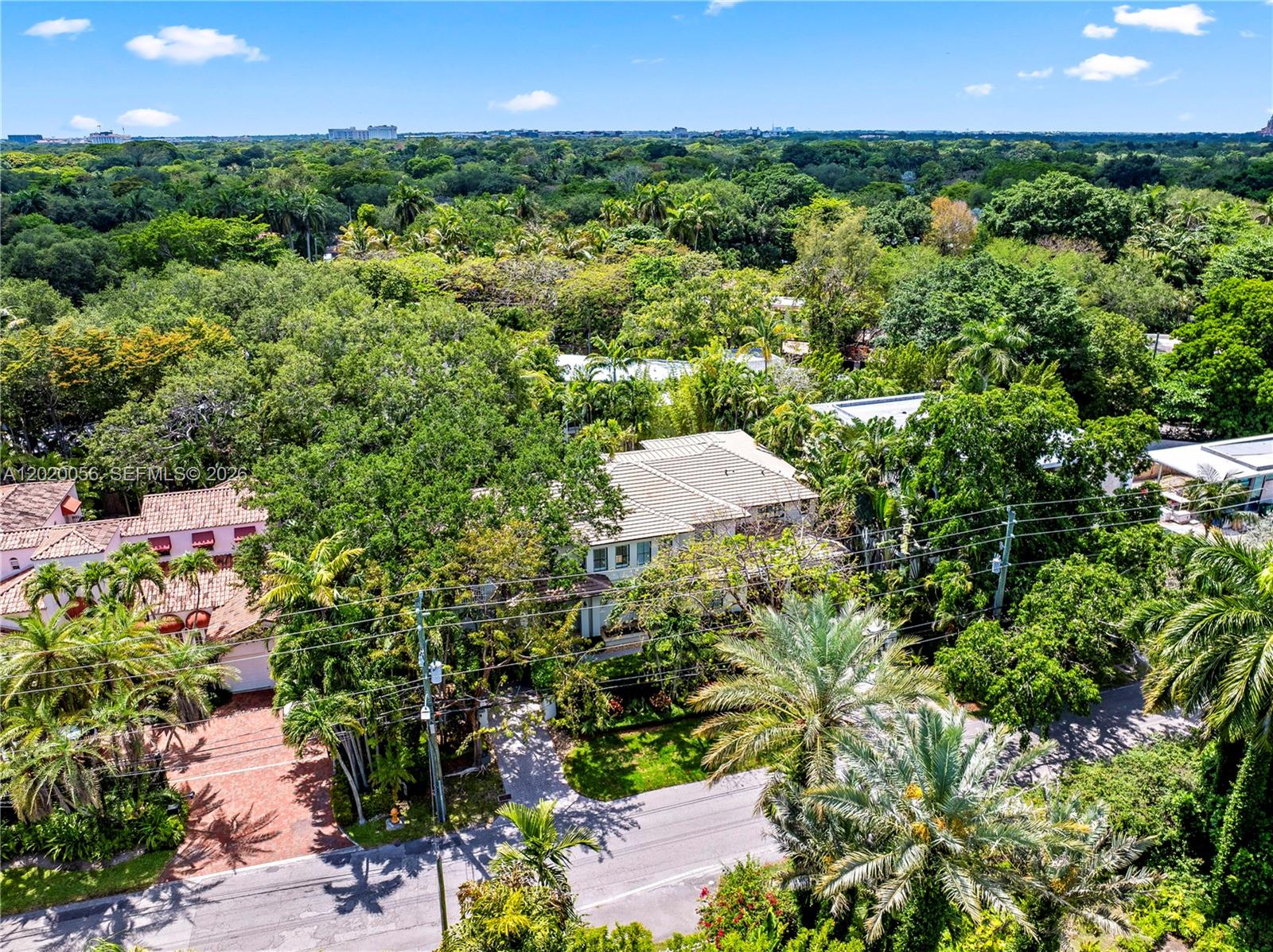 4196 Douglas Road Miami, FL 33133 - Photo 95 of 96 an aerial view of a house with a yard and lake view