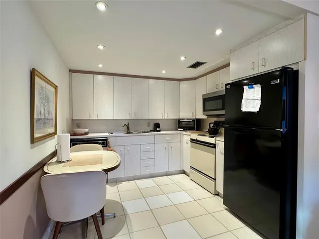 a kitchen with a sink cabinets and window