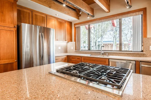 a kitchen with a stove and a white cabinets