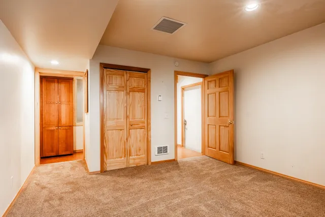 a bathroom with a sink a toilet a shower and a window