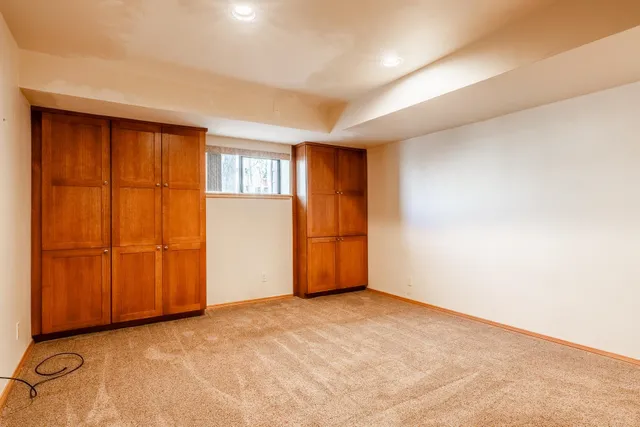 a view of a livingroom with wooden floor and a ceiling fan