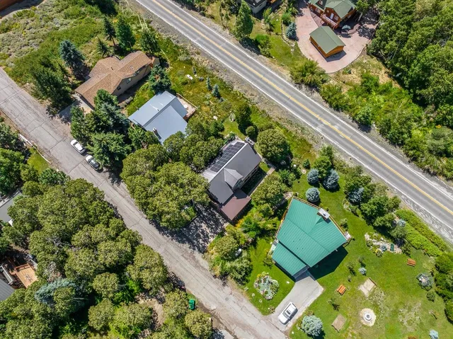 an aerial view of a house with a yard and garden