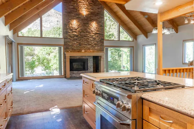 a kitchen with stainless steel appliances granite countertop a stove a sink and a refrigerator