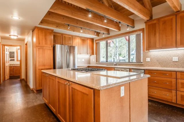 a kitchen with a stove a sink and a refrigerator