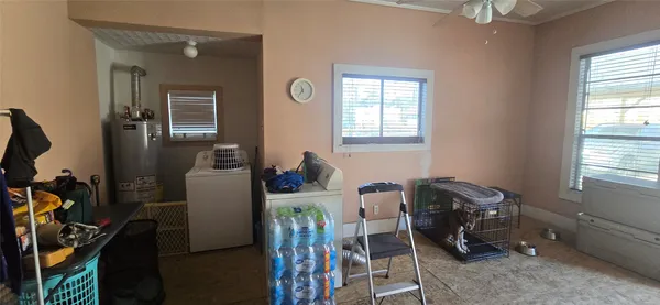 a room with furniture a flat screen tv and a window