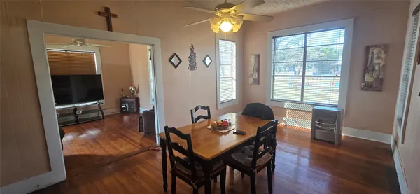 a view of a dining room with furniture window and wooden floor