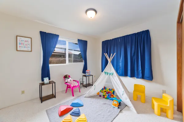 a children room with furniture and toys