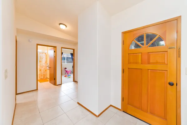 a view of an empty room with wooden door