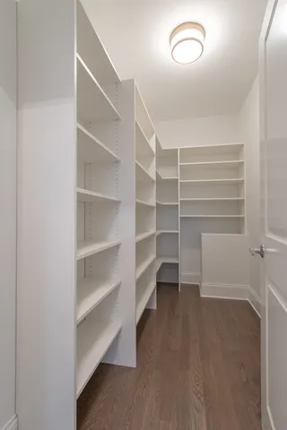 a view of walk in closet with empty racks